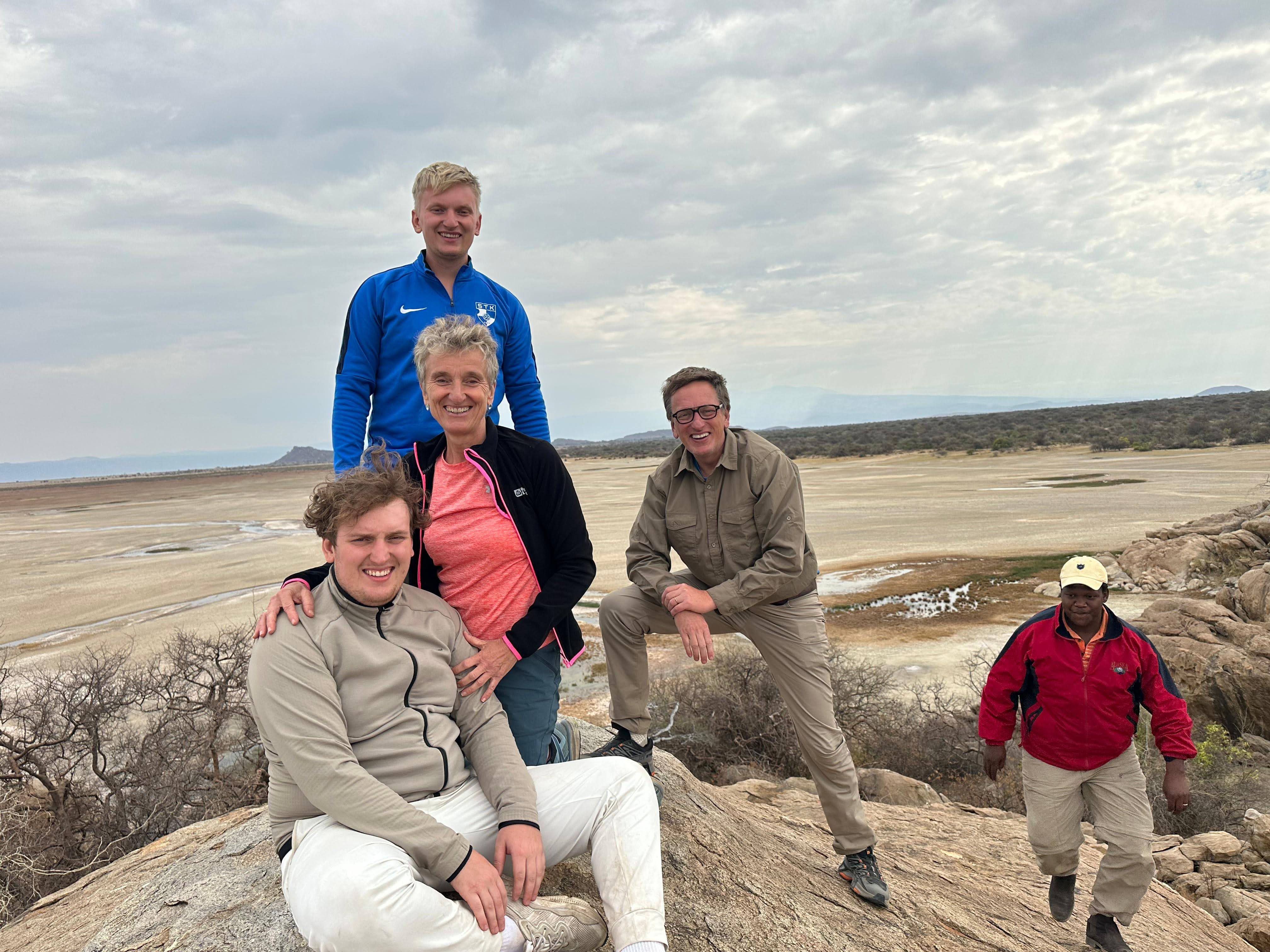 Pori and Beyond Safaris guests with their safari guide overlooking Tanzania
